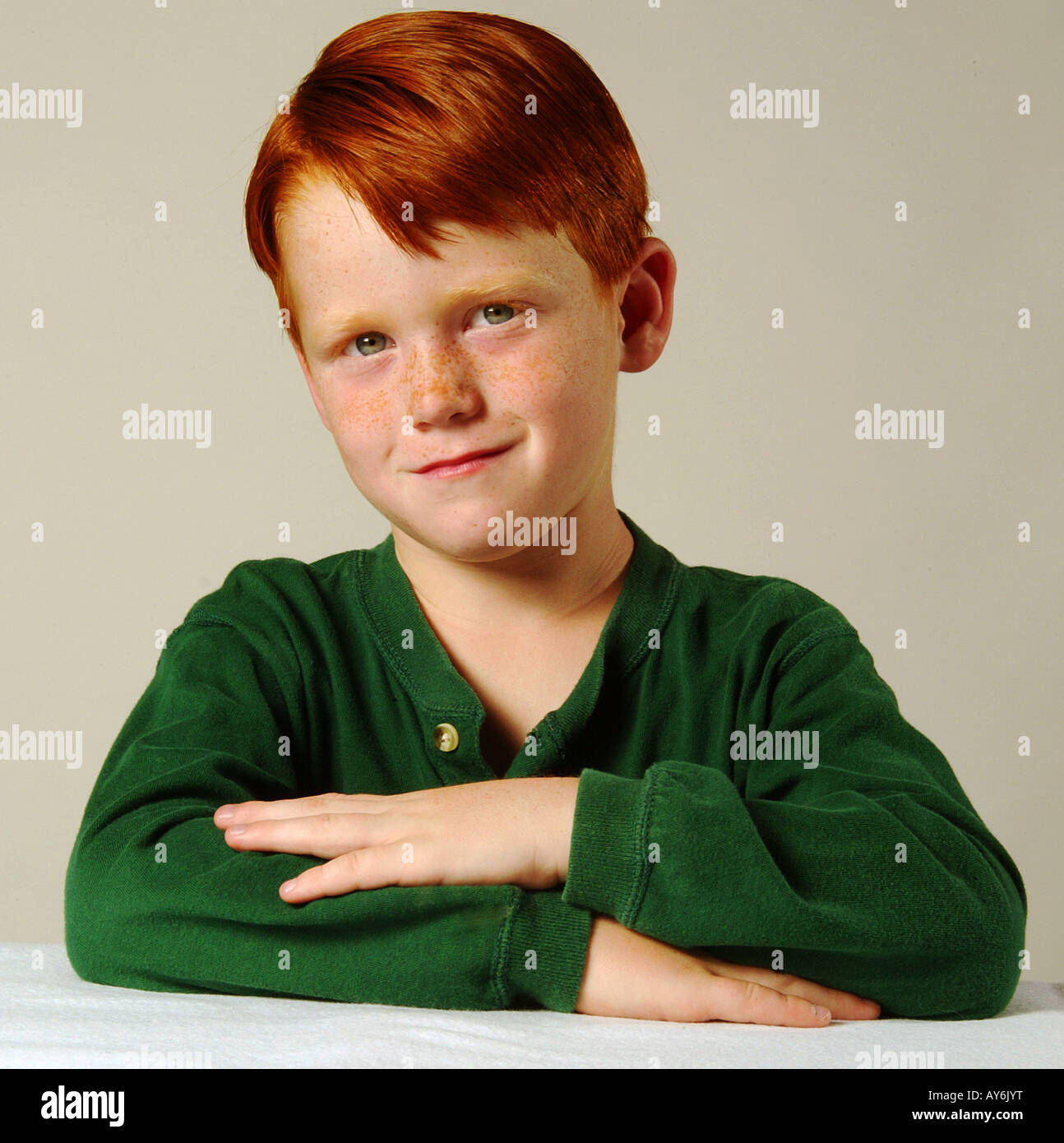 A 5 year old red headed Caucasian boy in a green shirt from Southern California MODEL RELEASE Stock Photo