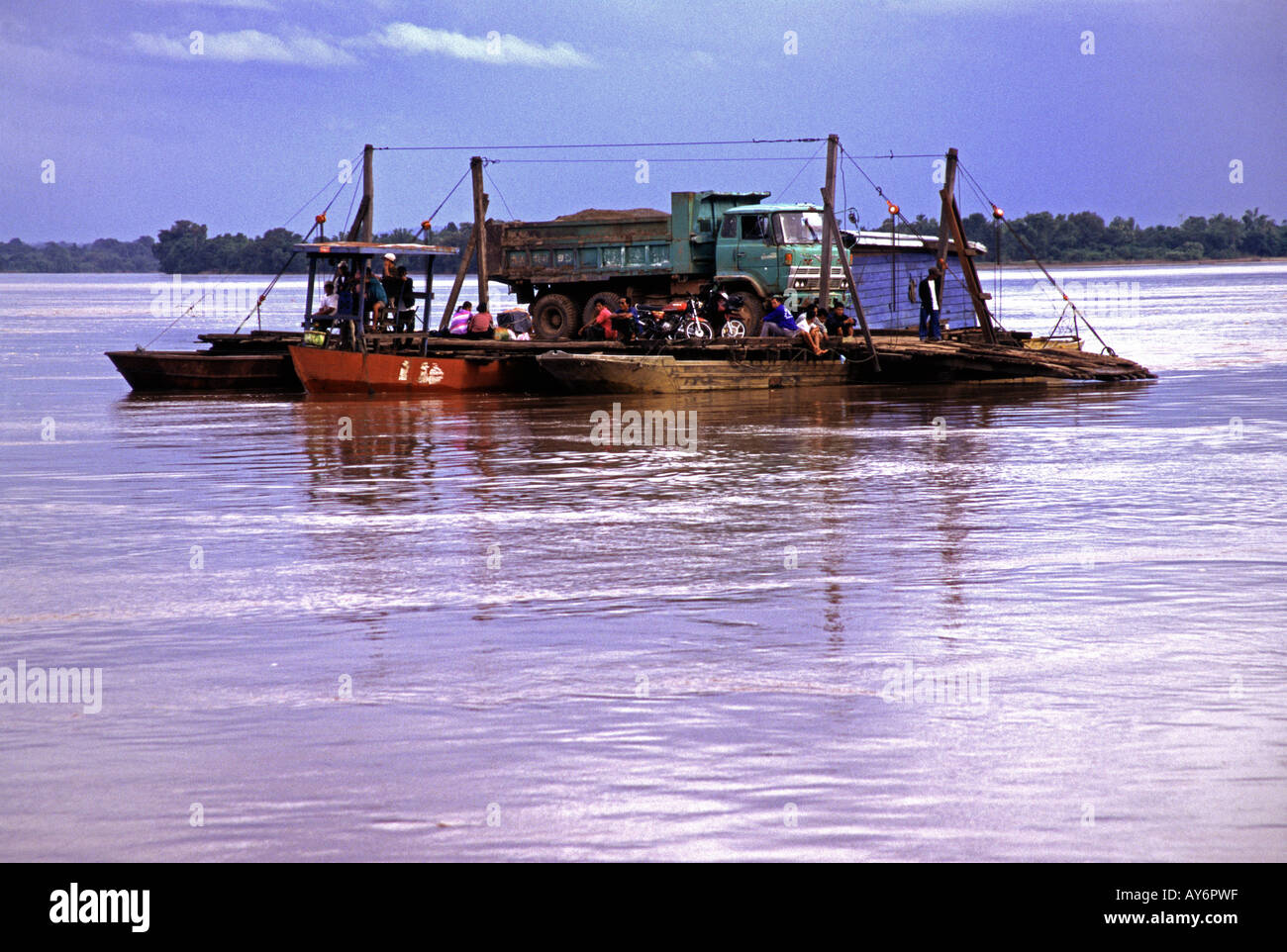 Small river ferry carrying a truck and foot passengers in southern Laos Stock Photo