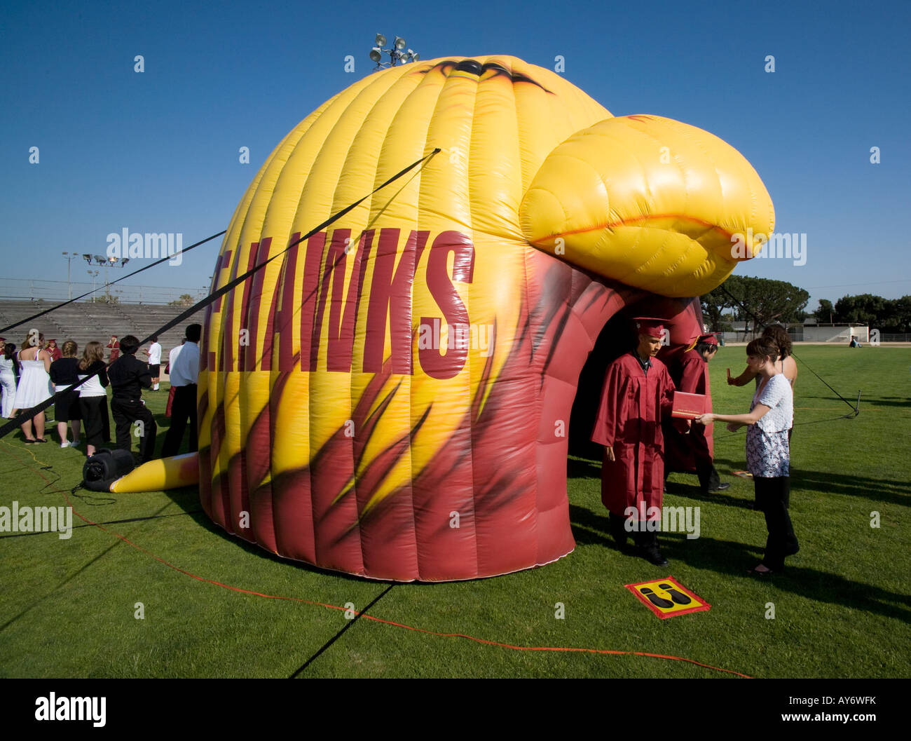 High school seniors pass through inflated replica of the schools