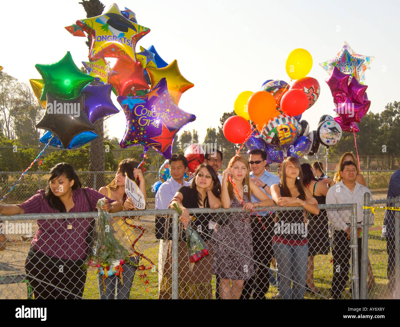 Families watch high school seniors during commencement Stock Photo - Alamy