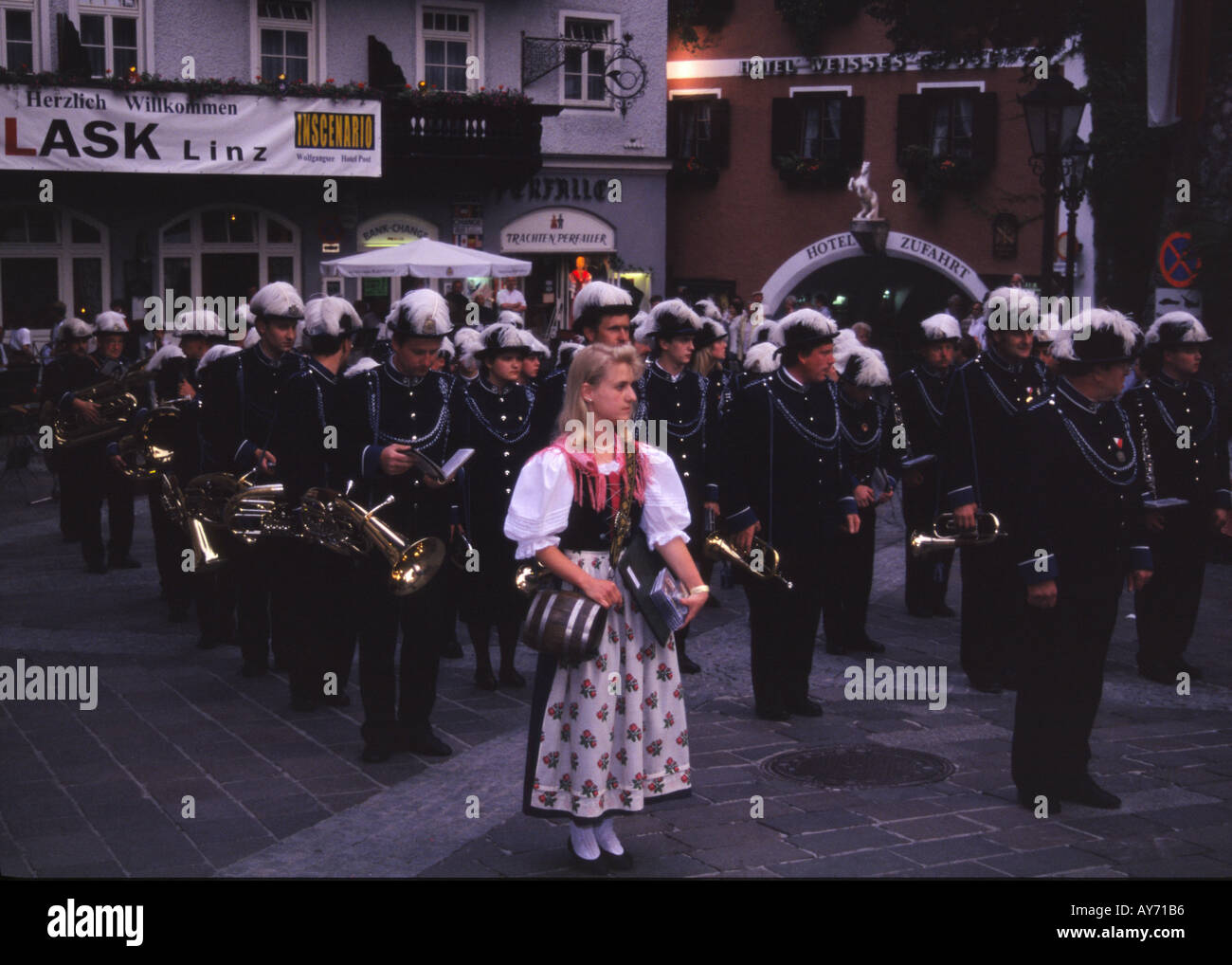 Girl dressed in traditional costume and brass band St Walfgang Austria Stock Photo