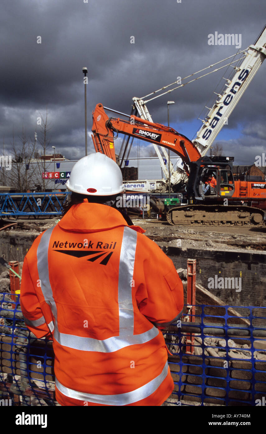 Railway Worker Surveying Progress Stock Photo
