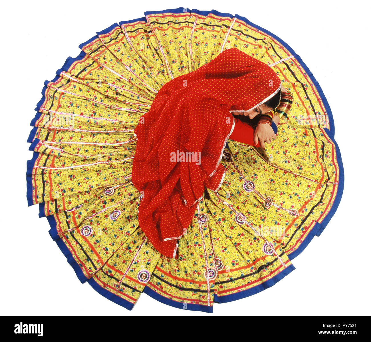 Single one top angle Indian Rajasthani Woman in circular round dress in yellow and red colour called Ghagara India Stock Photo