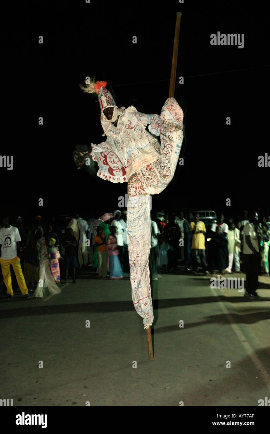 Stilt walker with left leg in the air at the Kartong festival The Gambia Africa Stock Photo Alamy
