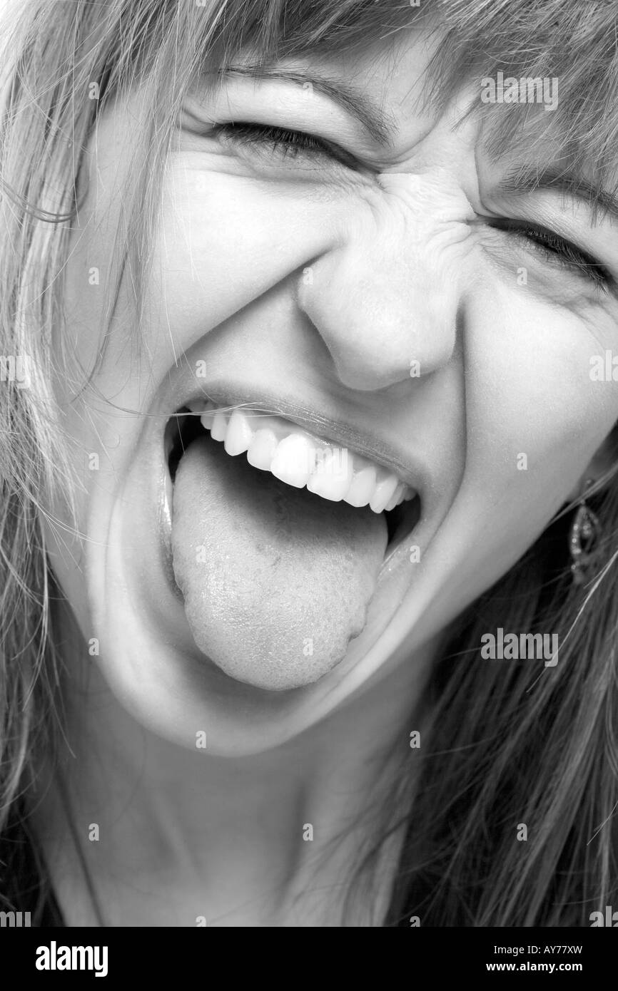 Woman sticking one's tongue at somebody Stock Photo