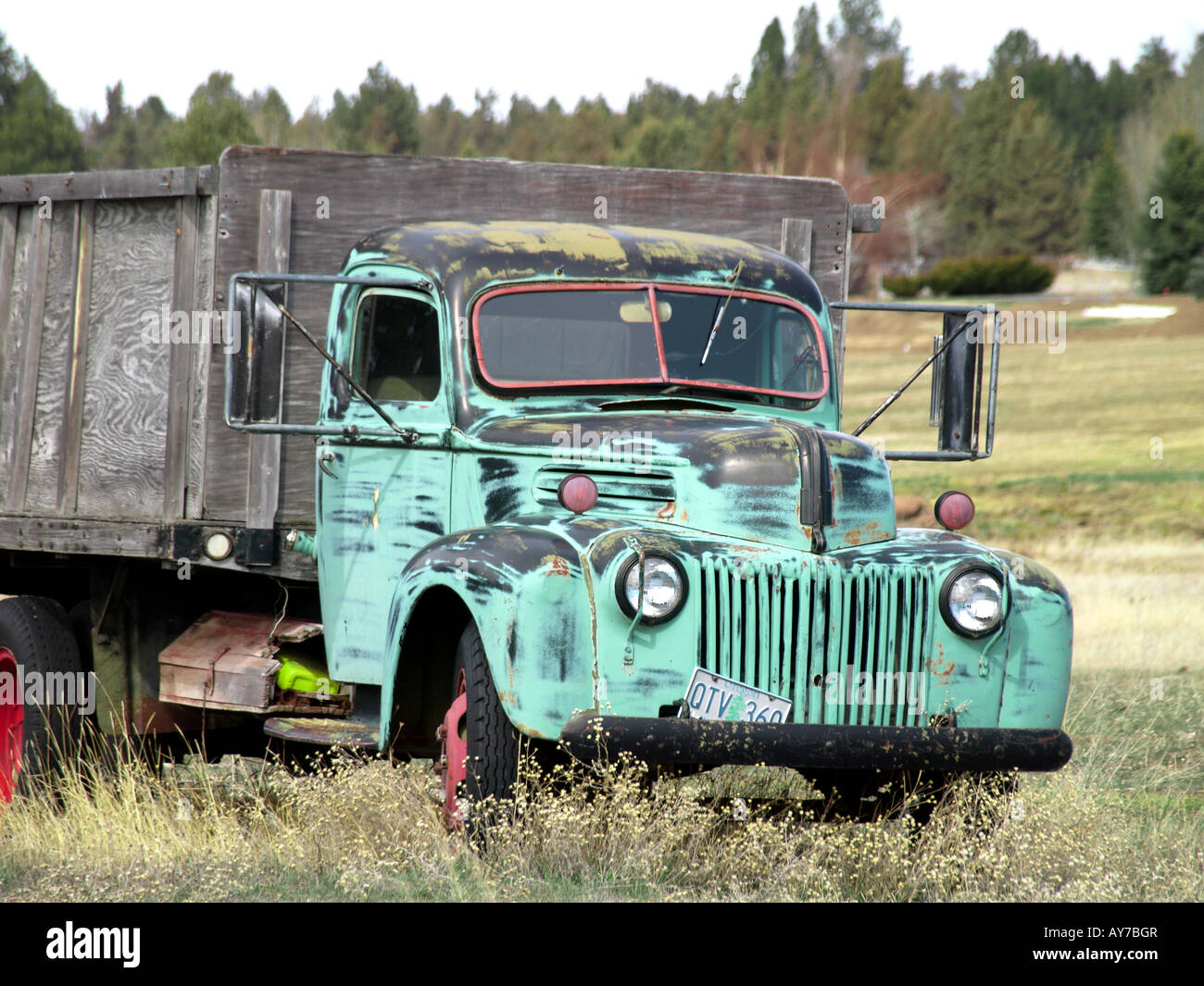 An ancient 1940 s stake truck sits abandoned in a field near Tumalo Reservoir Road Stock Photo