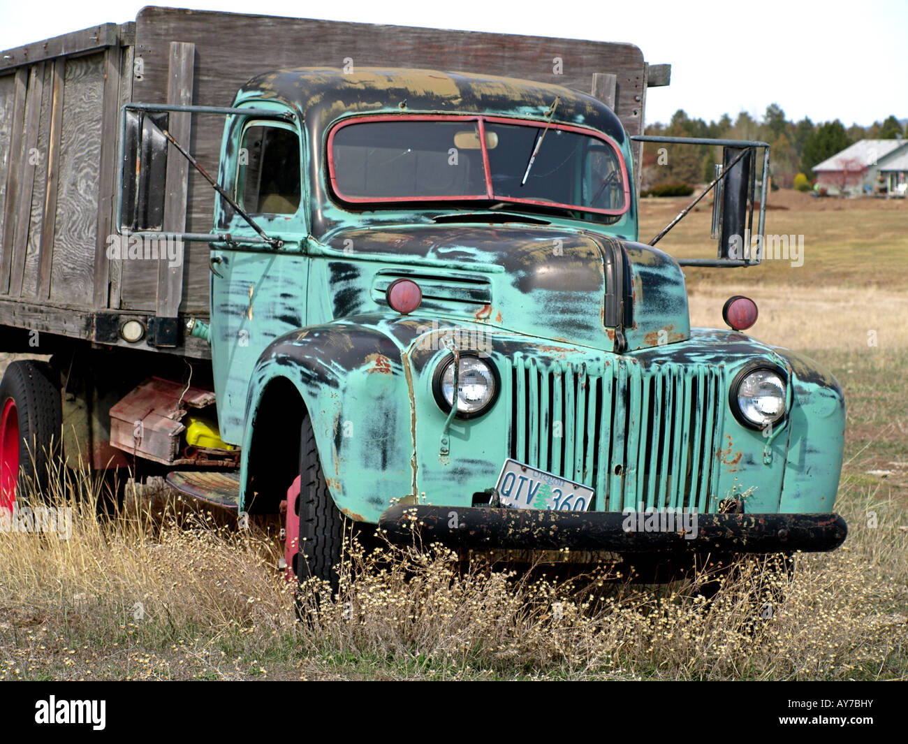 An ancient 1940 s stake truck sits abandoned in a field near Tumalo Reservoir Road Stock Photo