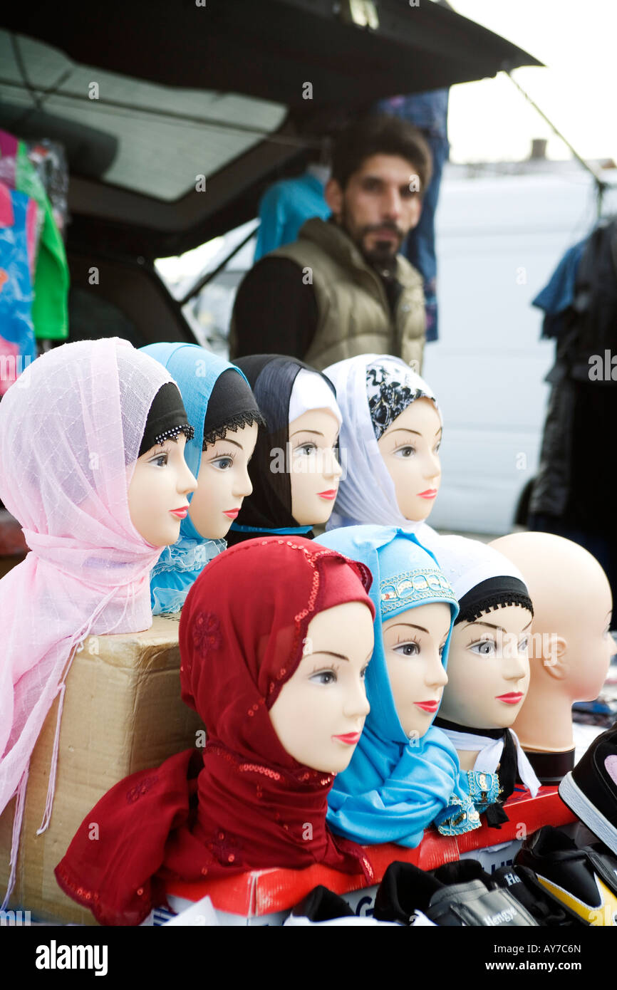 Shopkeeper with dolls wearing coloured Hijabs exhibited for sale at Hijab fashion Shop in a suburb of Gothenburg Sweden Stock Photo