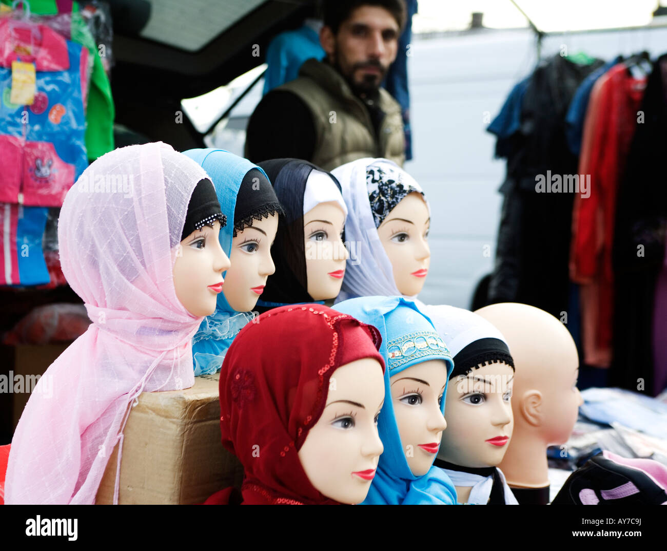 Shopkeeper exhibiting rows of dolls wearing coloured  Hijabs at Hijab Fashion Shop in a suburb of Gothenburg Sweden Stock Photo