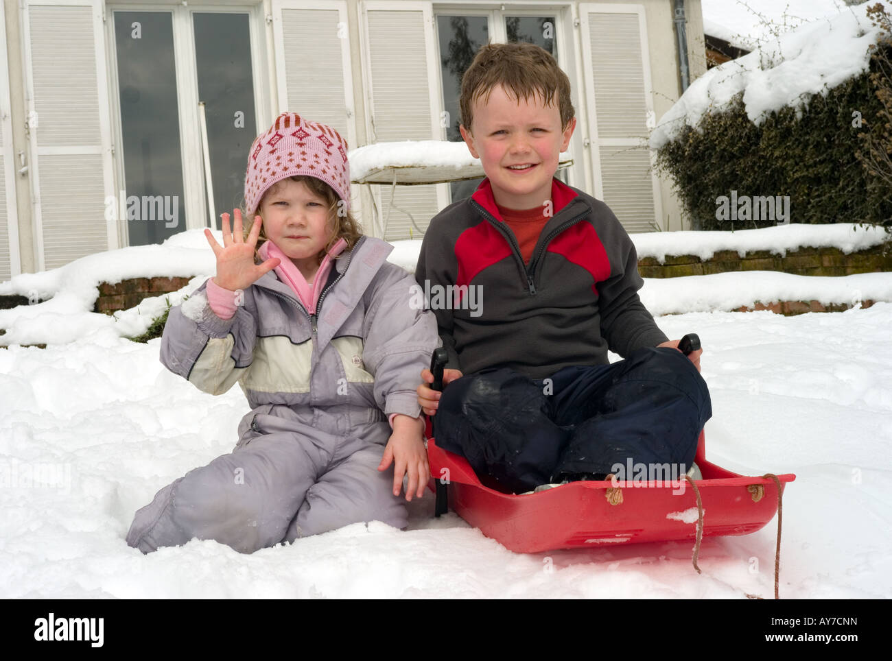 Siblings enjoying the snow Stock Photo - Alamy