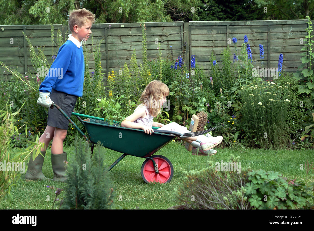 Children Gardening Little Boy with Girl in Wheelbarrow Stock Photo - Alamy