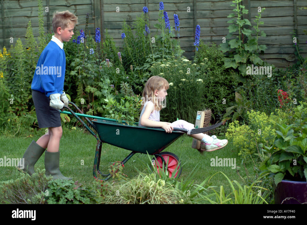 Children Gardening Little Boy with Girl in Wheelbarrow Stock Photo - Alamy