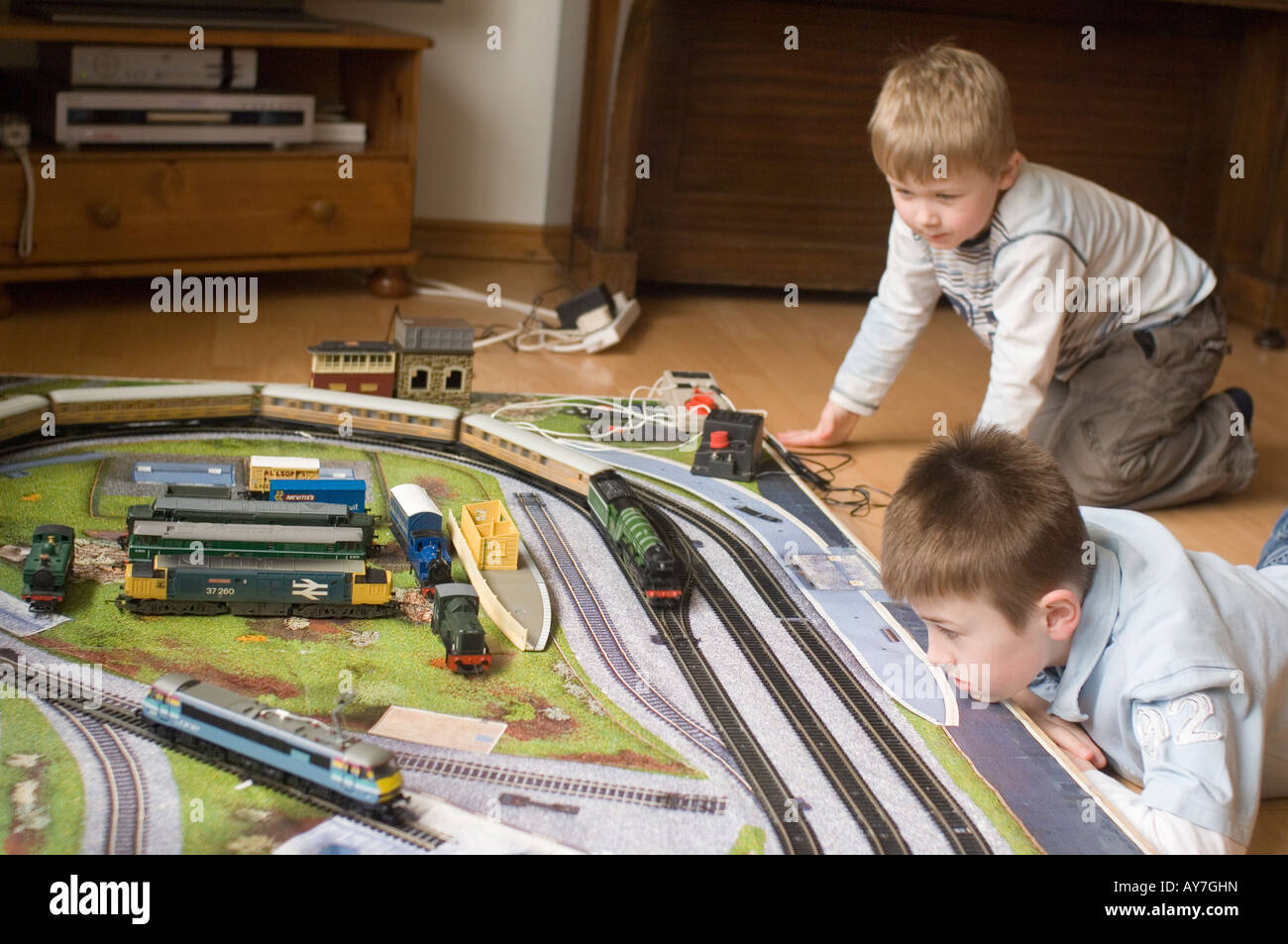 Boys Playing With Model Electric Trains Stock Photo Alamy