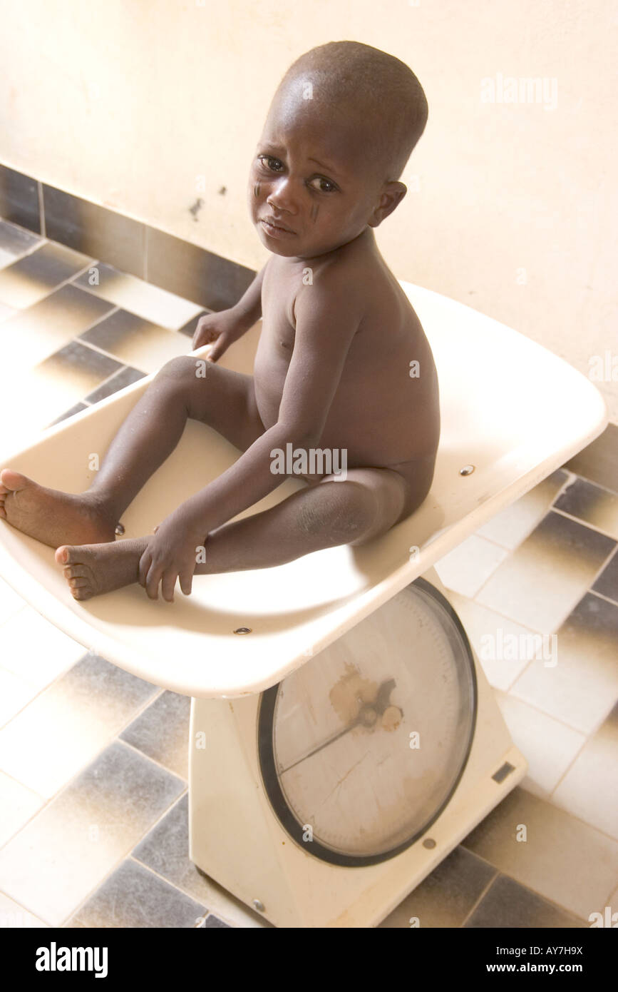 African child being weighed at health clinic run by the Red Cross in Agadez Niger West Africa Stock Photo