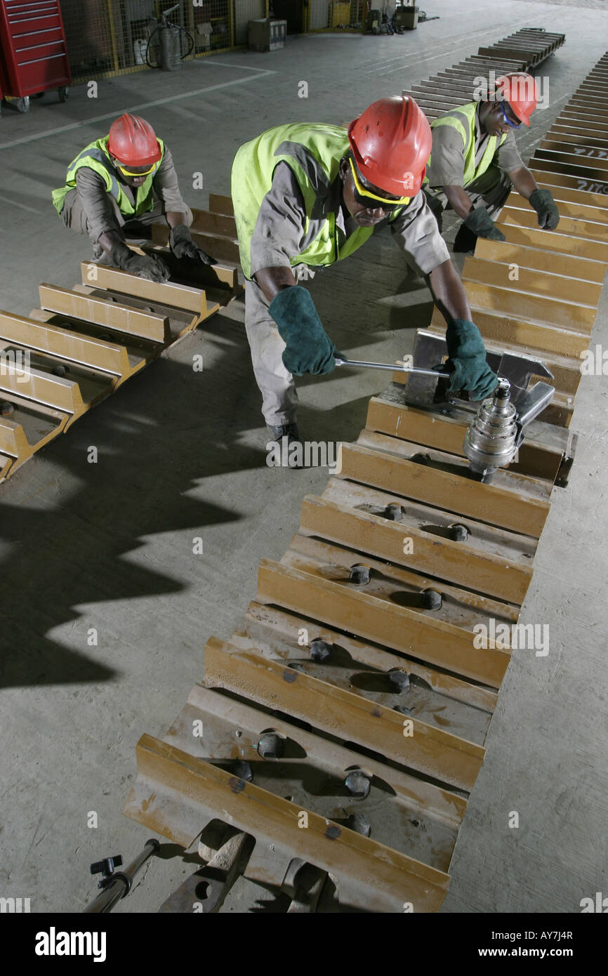 Repairing track of Caterpillar bulldozer mining vehicle in maintenance
