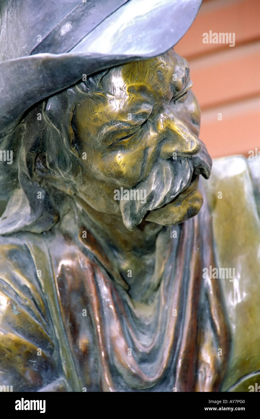 A bronze sculpture of a weathered cowboy stands in front of Sonya's Gallery, in the  mountain town of Ruidoso, New Mexico. Stock Photo