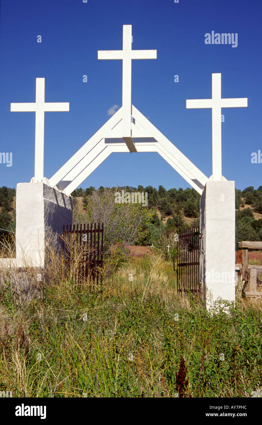 This magnificent gateway to an old, overgrown and neglected cemetery can be  found in Tres Ritos, New Mexico. Stock Photo