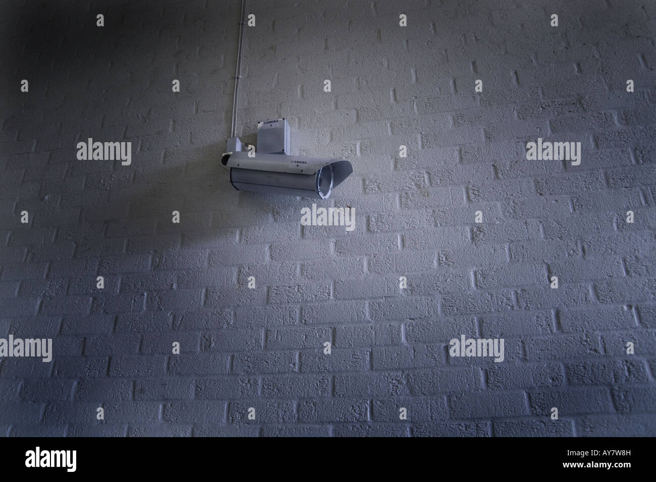 CCTV video camera on white brick wall surveillance Stock Photo Alamy