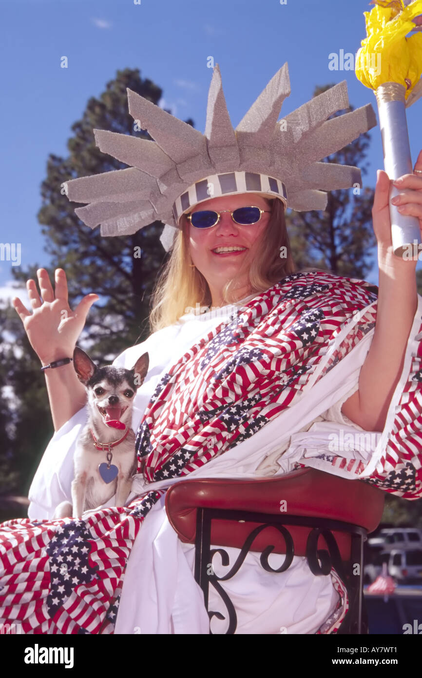 Smiling woman in patriotic costume waves to the crowd at the Aspenfest Parade, in downtown Ruidoso, New Mexico. Stock Photo