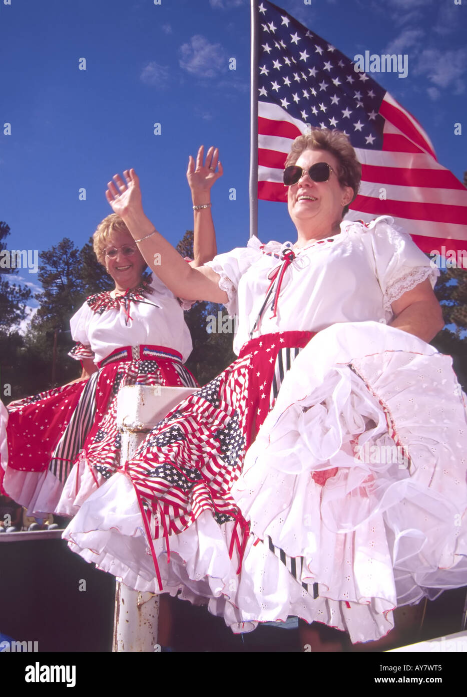 Patriotic ladies wave to the crowd at the Aspenfest Parade in downtown Ruidoso, New Mexico. Stock Photo