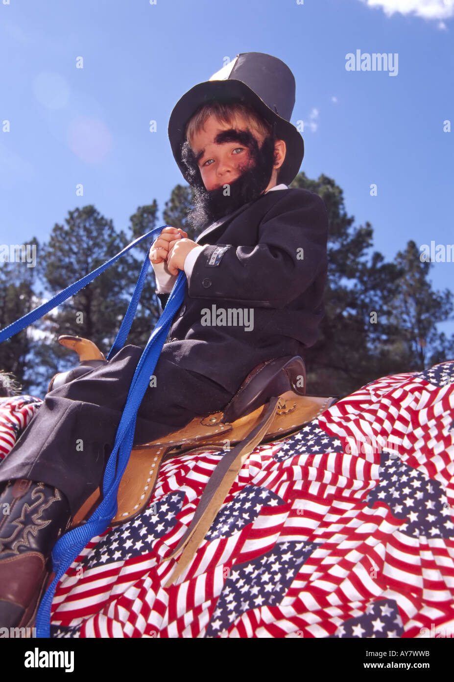 A young boy portraying Abe Lincoln rides with pride in the Aspenfest Parade, in downtown Ruidoso, New  Mexico. Stock Photo