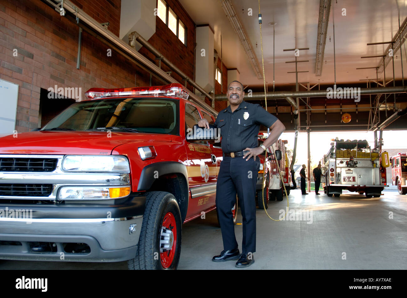 Chief Battalion firefighter standing next to pickup truck Stock Photo
