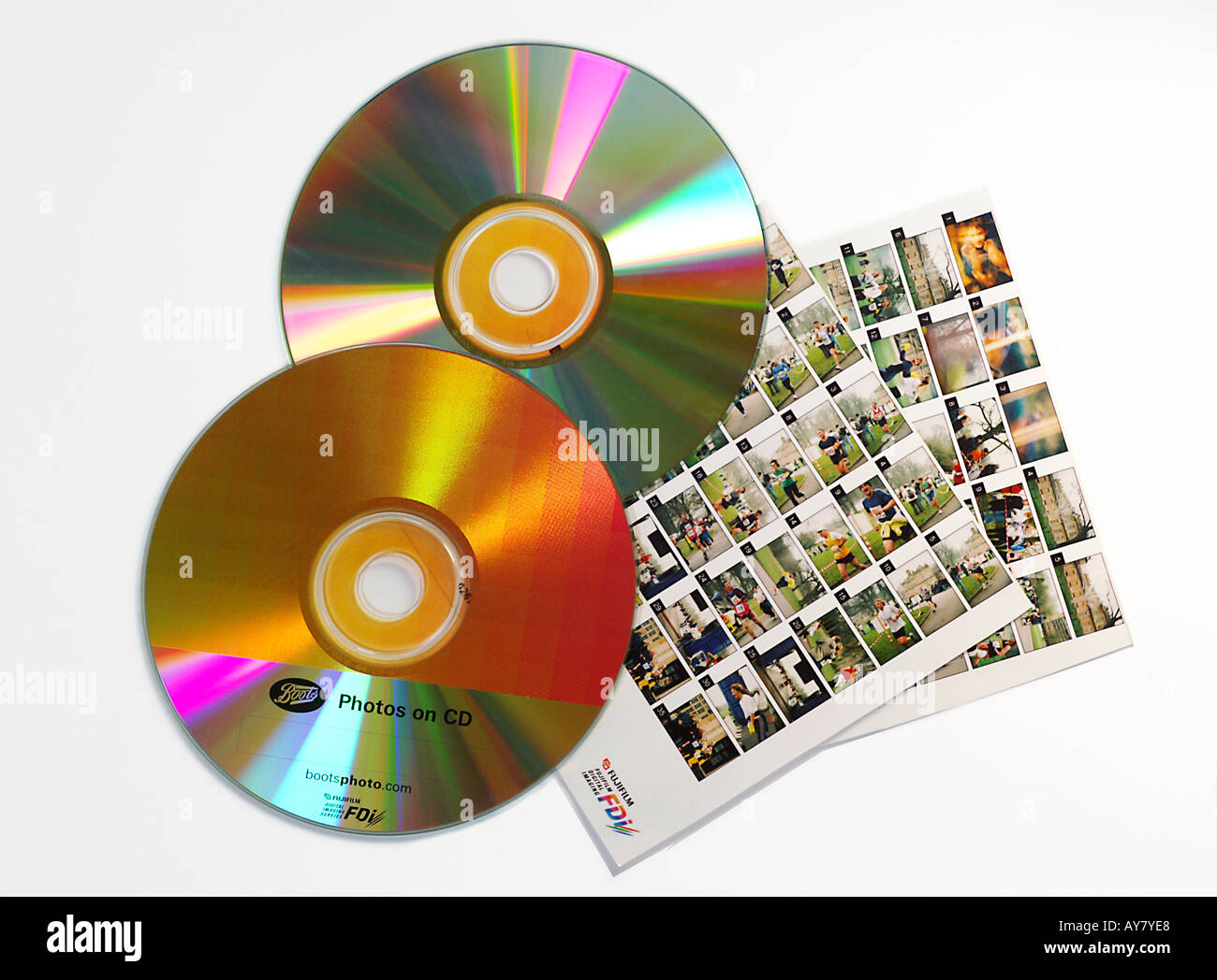 Recordable CDs containing pictures as returned from processing laboratory with index prints showing miniature thumbnail images Stock Photo