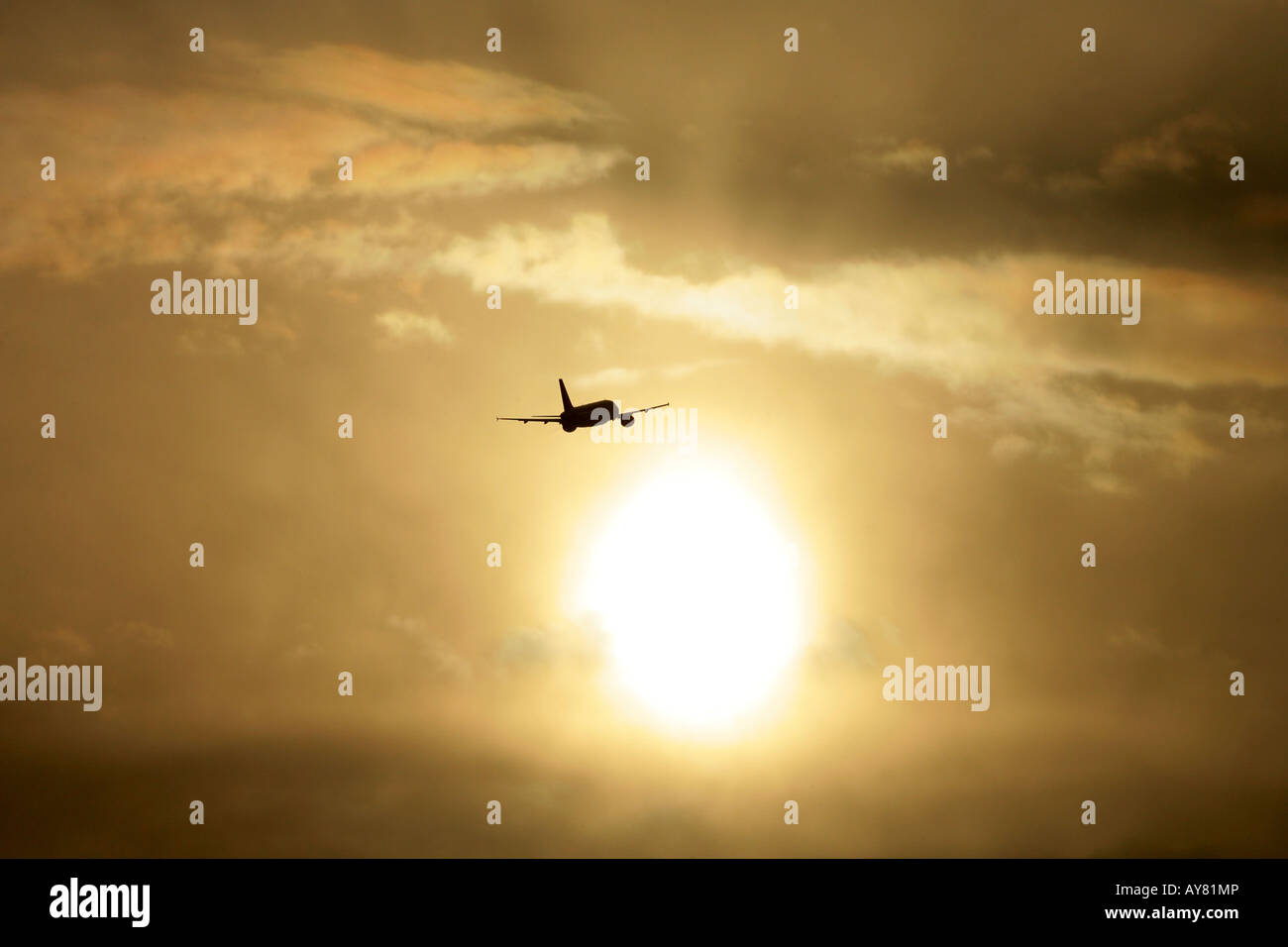 Aircraft taking off at sunset Stock Photo