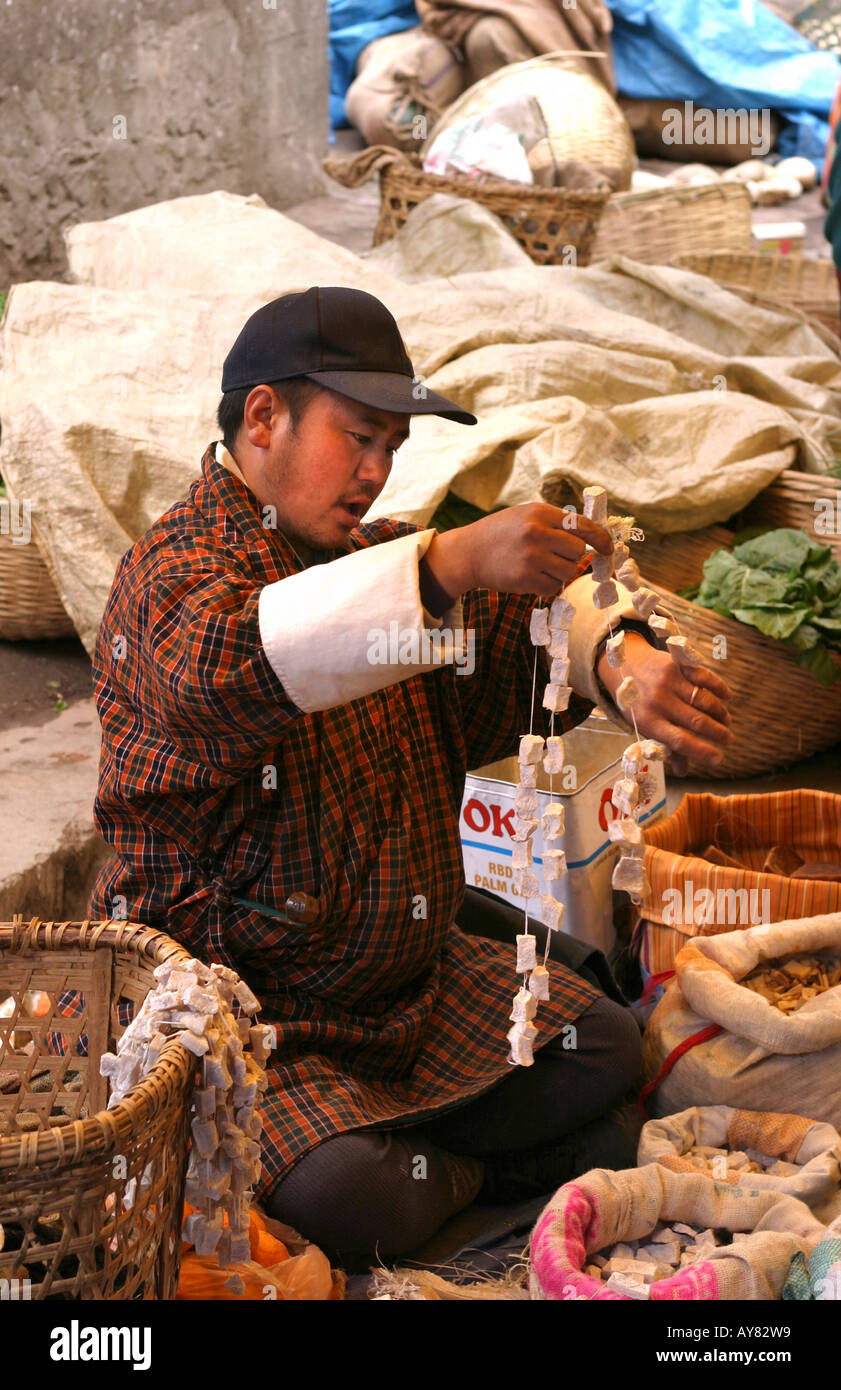 Bhutan Thimpu market food man selling dried yak cheese Stock Photo Alamy