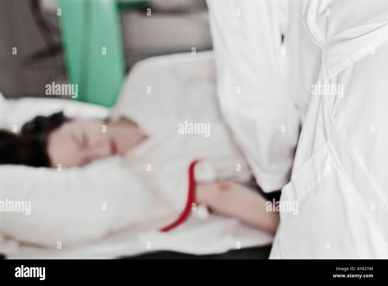 Doctor Attending To Female Patient In Hospital Stock Photo