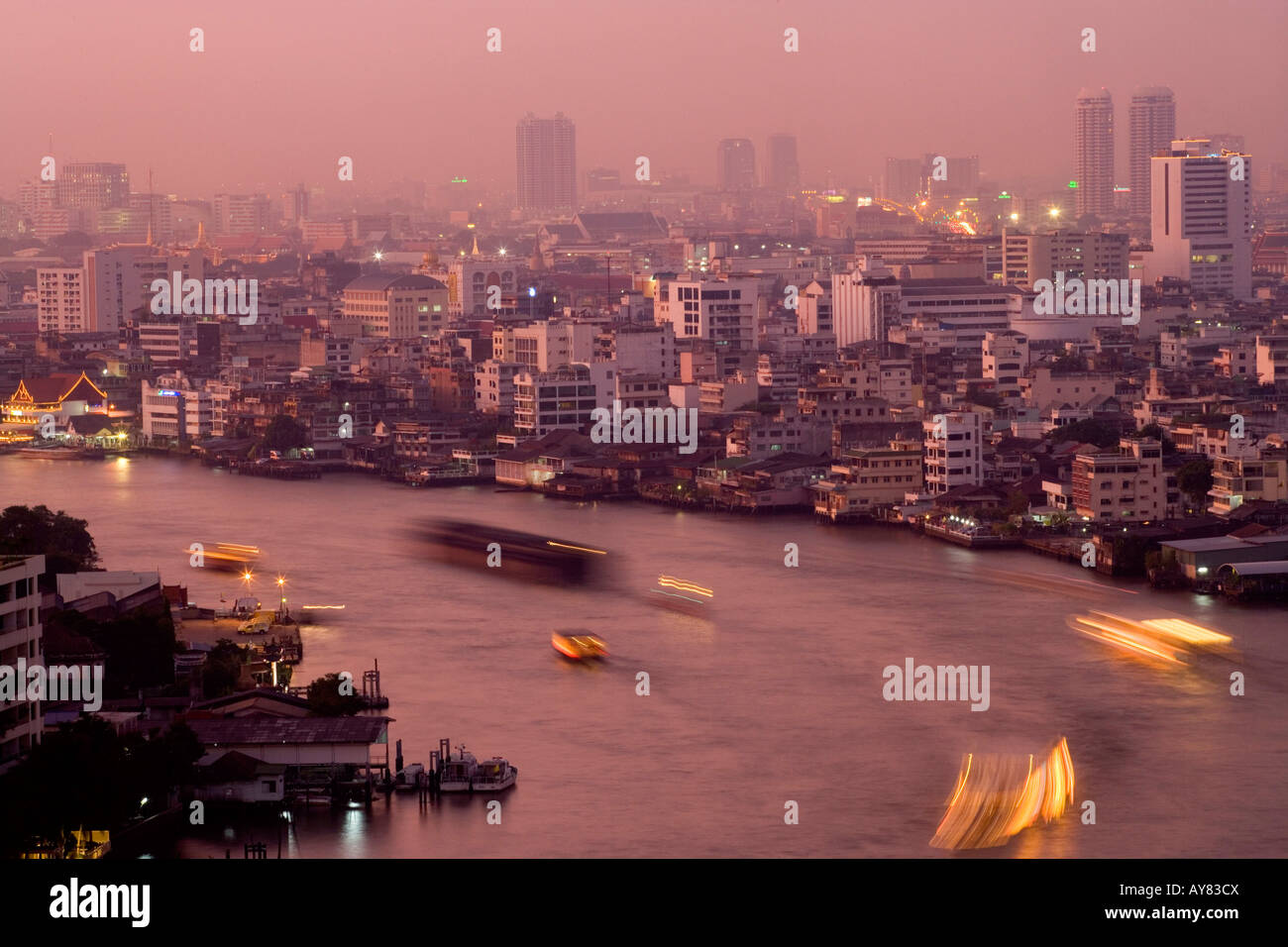 The river Chao Phraya with boat traffic cuts through Bangkok Thailand ...