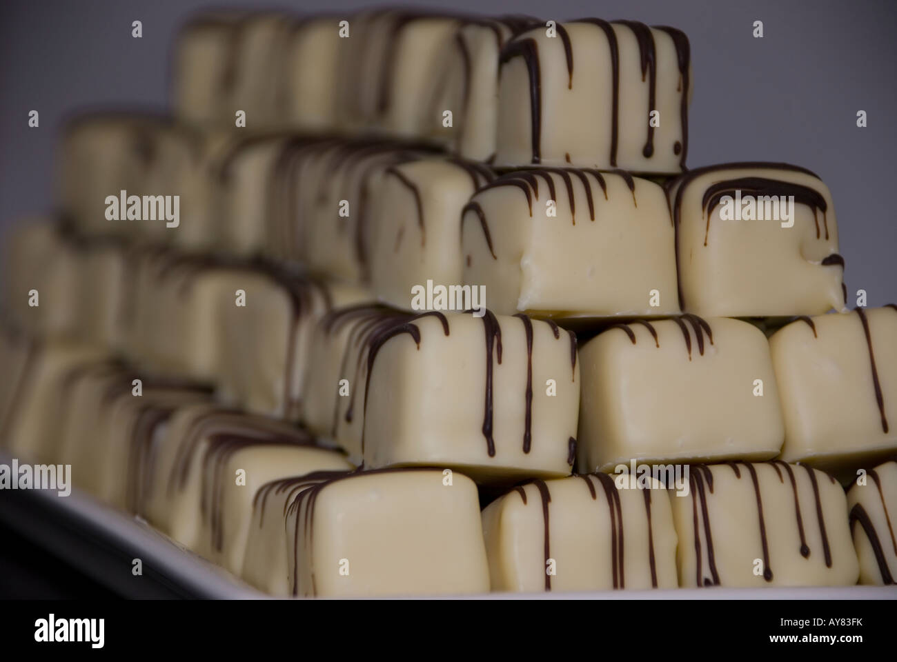 The art of the chocolatier, hand made white chocolates decorated with milk chocolate Stock Photo