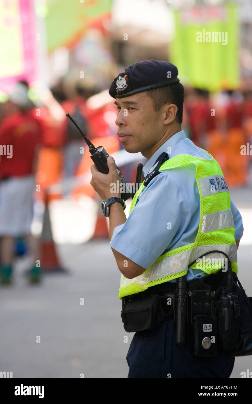 Hong Kong Policeman talking on walkie talkie Stock Photo