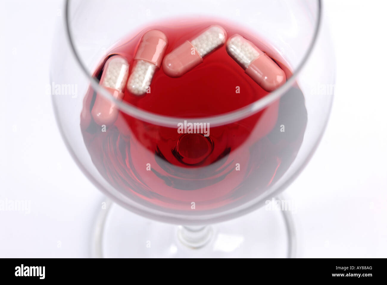 Dangerous mixture: alcohol and pills Stock Photo