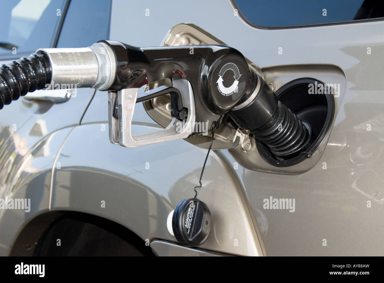 A gasoline pump fills a car with premium fuel Stock Photo