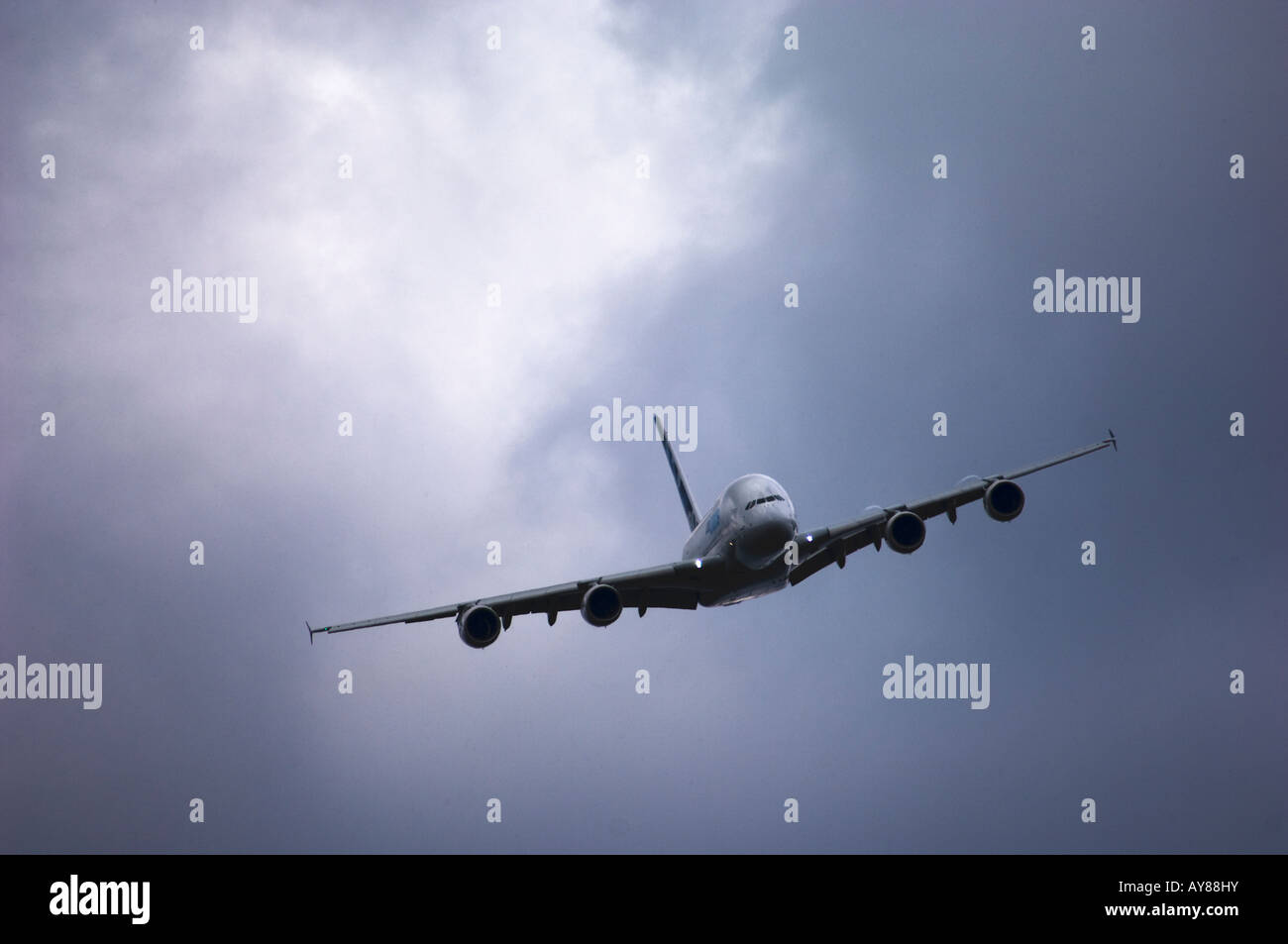 An Airbus A380 in flight, flying towards the camera through a cloudy ...