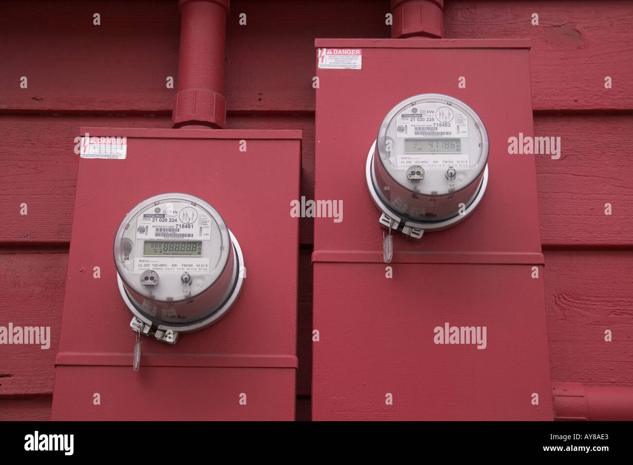 Two electric meters on red painted wall Stock Photo Alamy