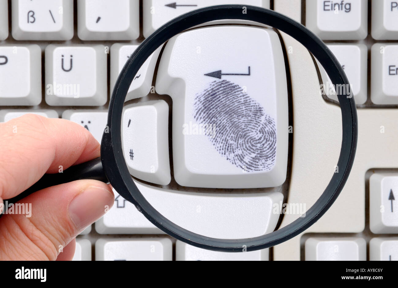 Online searching, fingerprint on keyboard Stock Photo