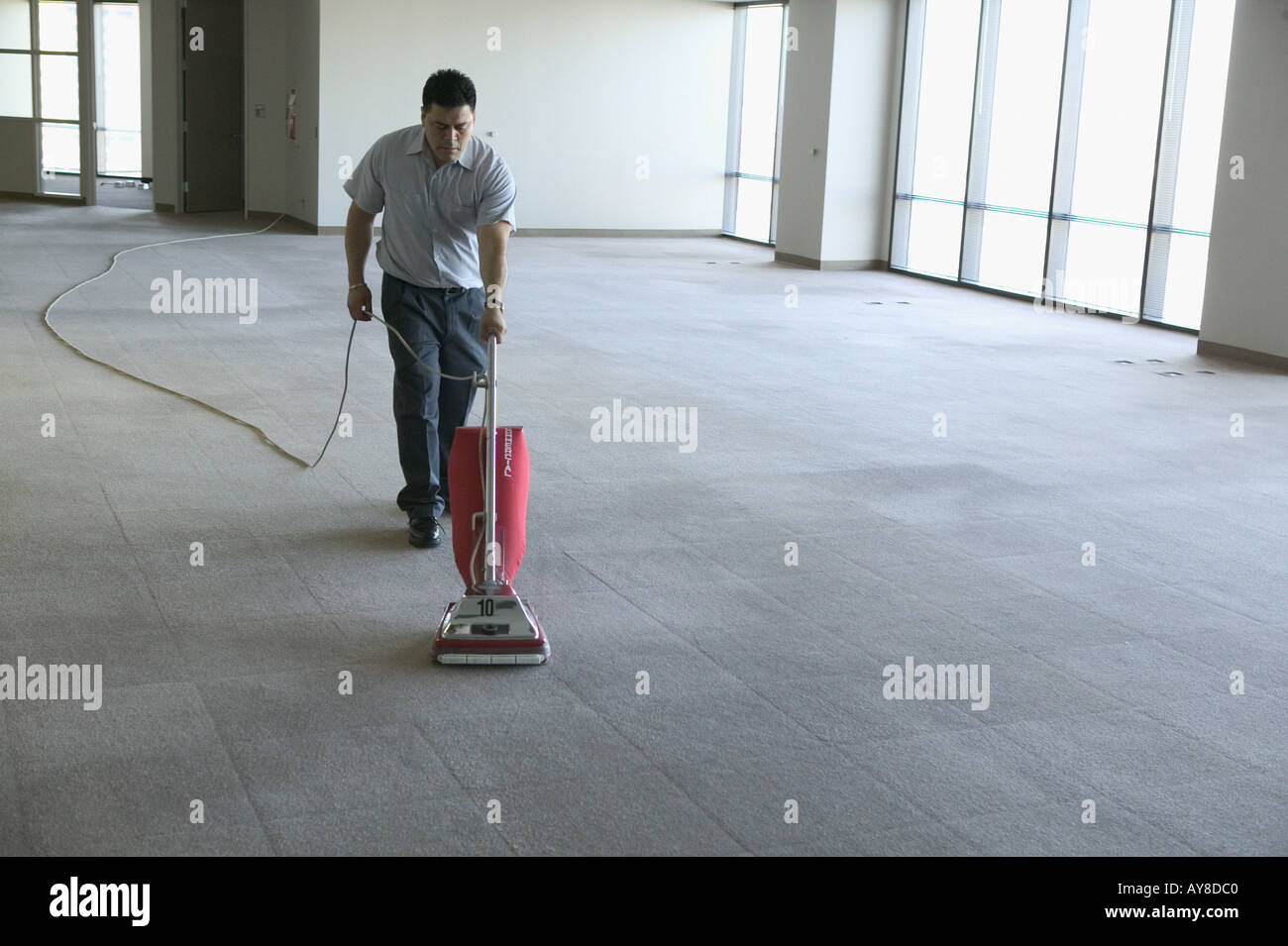 Vacant office building is being vacuumed by janitor after company moved out or about to move in Stock Photo