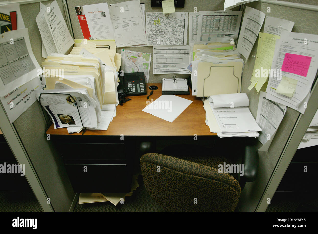 Messy cubicle in highrise office building Stock Photo