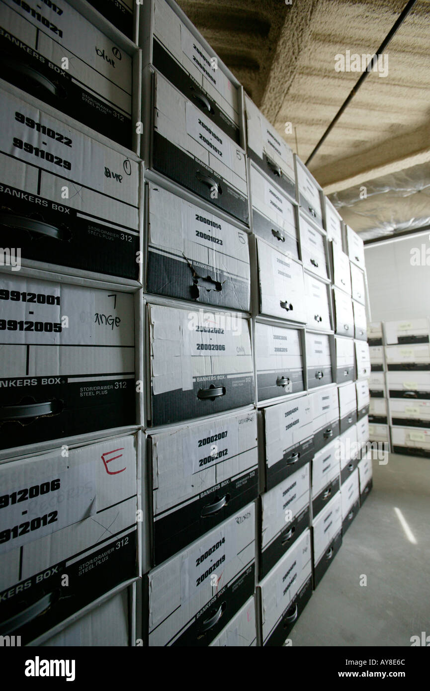 Files of paperwork stored in boxes in office building storage facility Stock Photo