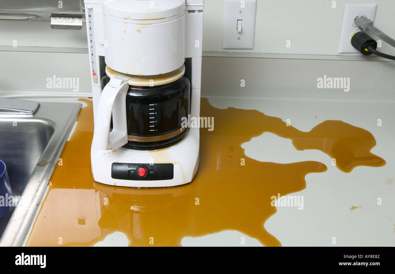 Coffee maker leaking coffee in office kitchen Stock Photo
