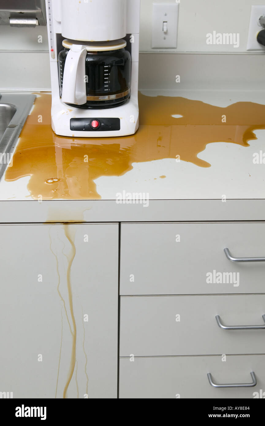 Coffee maker leaking coffee in office kitchen Stock Photo Alamy