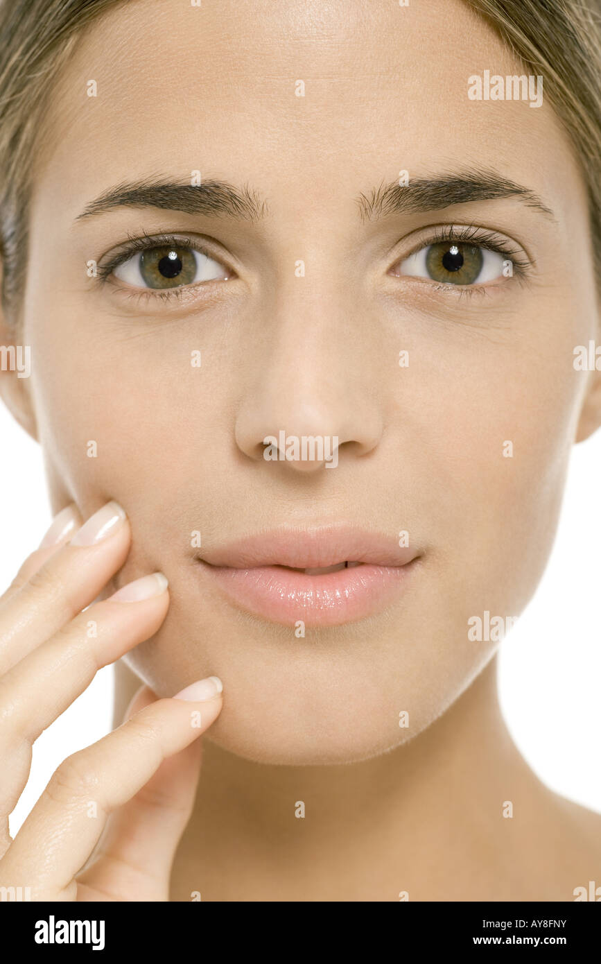 Woman's face, fingers on cheek, close-up Stock Photo