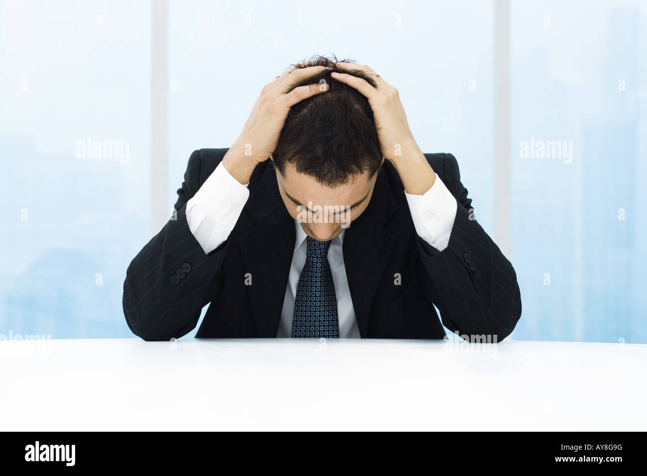 Businessman holding head Stock Photo