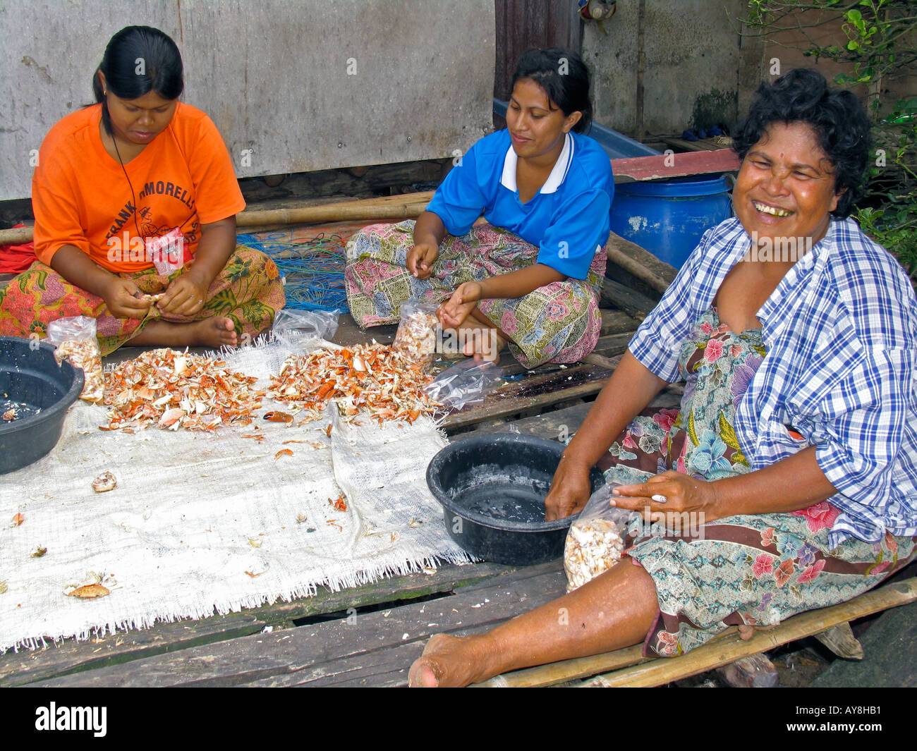 Women shelling and packing crab Ban Batu fishing village Ko Libong