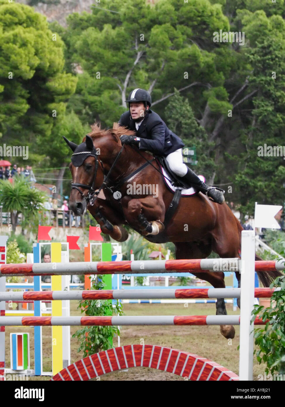 horse and rider jumping over obstacle during equestrian competition Stock Photo