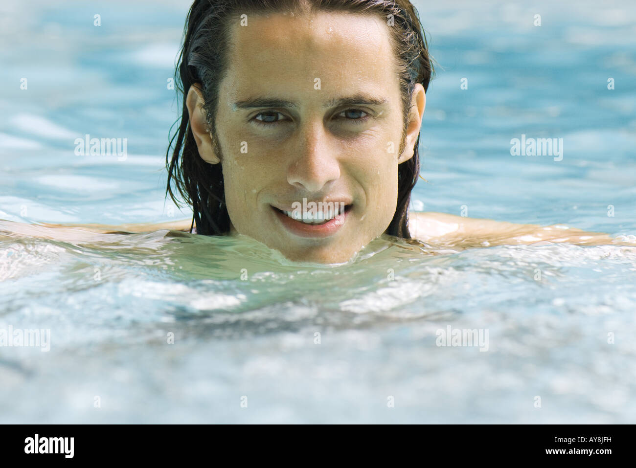 Man in swimming pool, smiling at camera, portrait Stock Photo