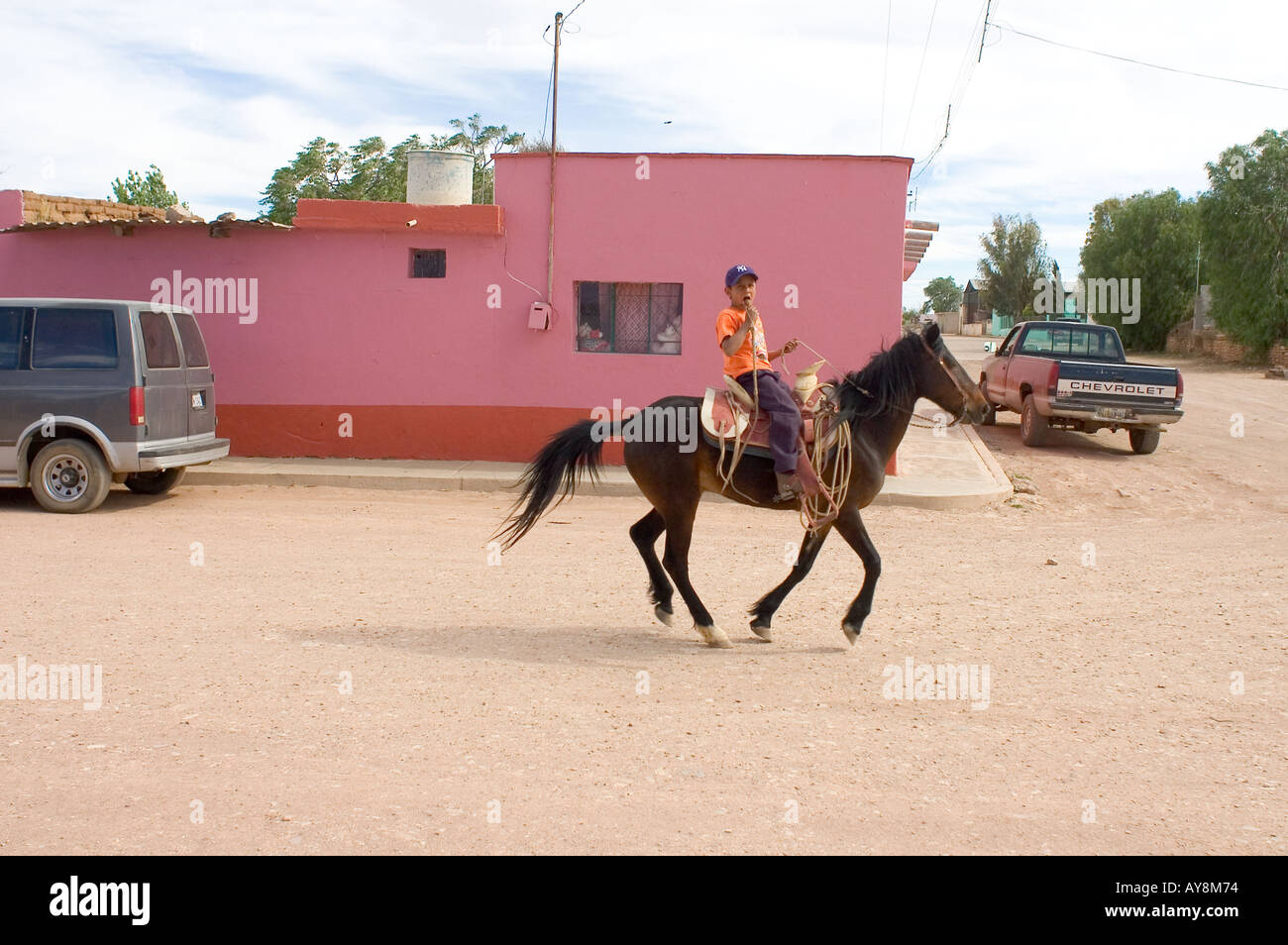 A young boy rides a horse in the small mining village of Francisco Madero, Zacatecas. Stock Photo