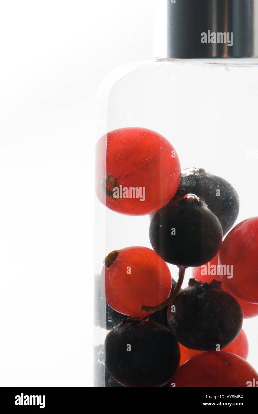 Fresh berries in cosmetic bottle Stock Photo